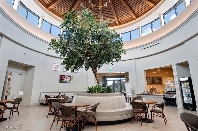 dining space with baseboards, a high ceiling, and a notable chandelier