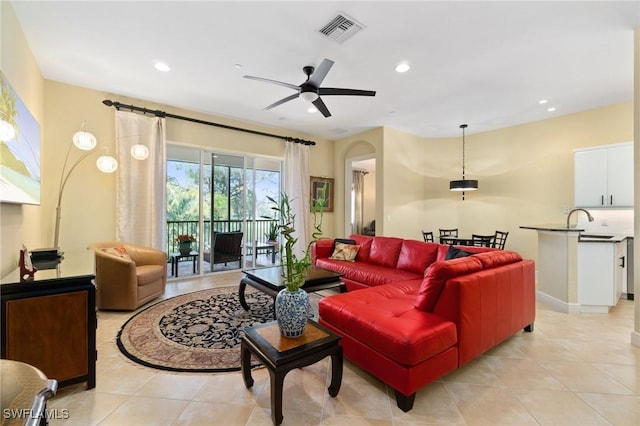 living area with a ceiling fan, recessed lighting, visible vents, and light tile patterned floors