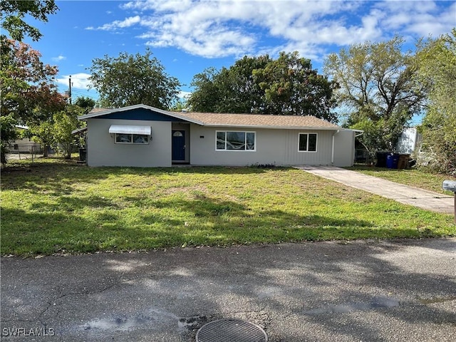 ranch-style house with fence and a front yard