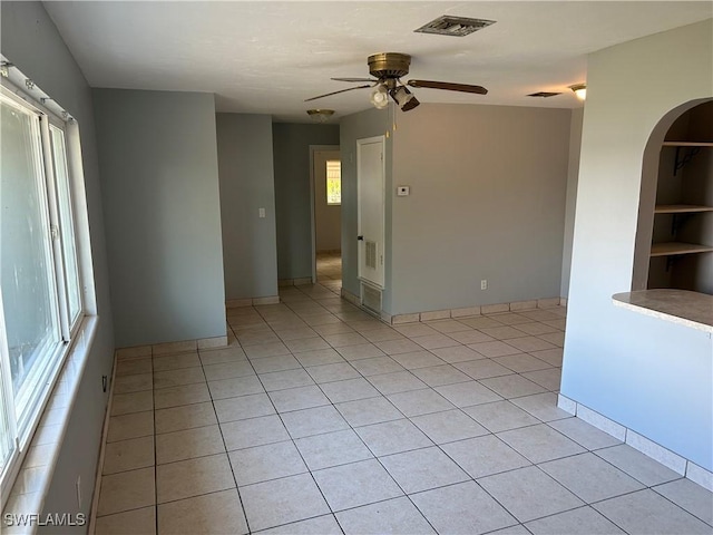 spare room featuring light tile patterned floors, plenty of natural light, and visible vents