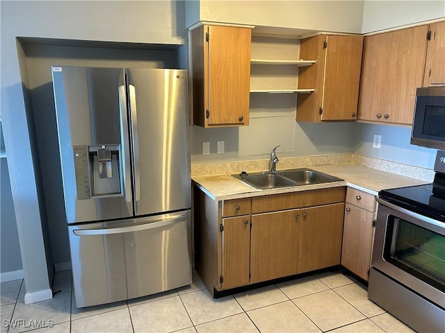 kitchen with brown cabinets, stainless steel appliances, light countertops, open shelves, and a sink