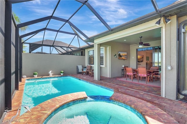 view of pool featuring ceiling fan, a lanai, a pool with connected hot tub, outdoor dining space, and a patio area