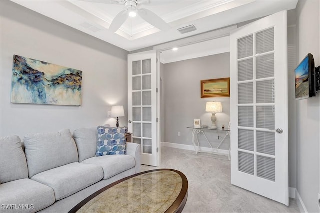 living area featuring ceiling fan, crown molding, visible vents, and baseboards