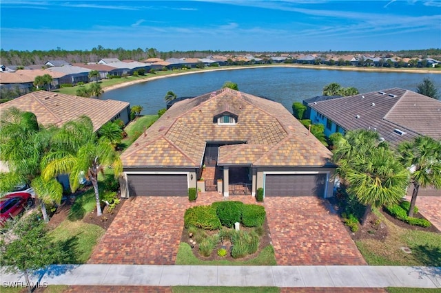 birds eye view of property with a water view and a residential view