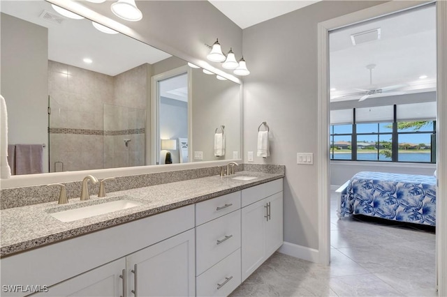 full bath with a sink, ceiling fan, and ensuite bath