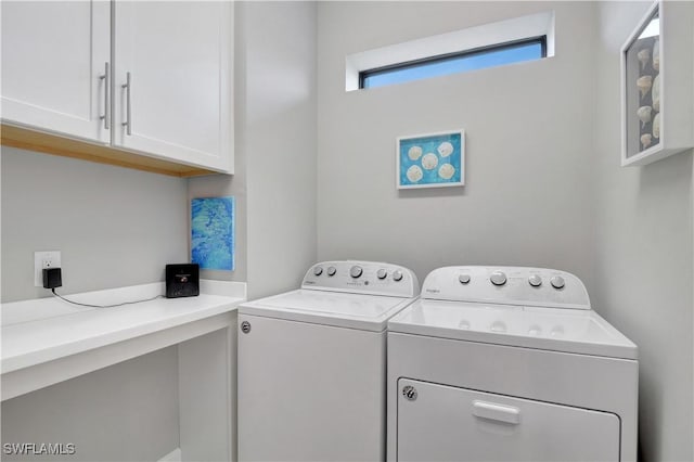 washroom with cabinet space and washing machine and clothes dryer