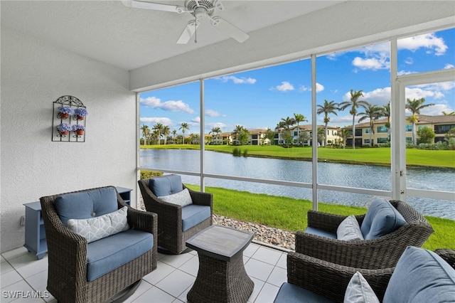 sunroom with a water view and a ceiling fan