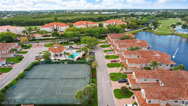 drone / aerial view with a water view and a residential view