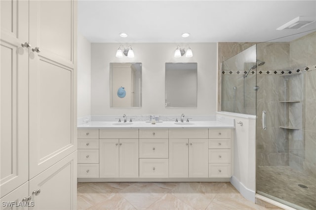 full bathroom featuring visible vents, a sink, a shower stall, and double vanity