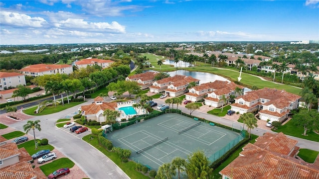 aerial view with view of golf course, a water view, and a residential view