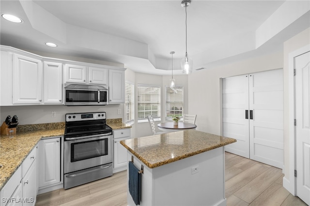 kitchen featuring stainless steel appliances, recessed lighting, white cabinetry, and light wood-style flooring