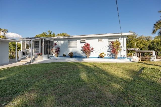 back of house with a lawn