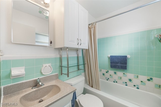 bathroom featuring shower / bath combination with curtain, tile walls, toilet, and vanity