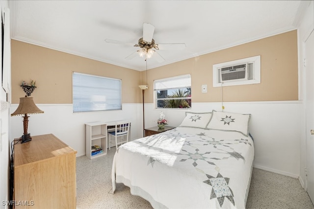 bedroom featuring a wall mounted AC, ceiling fan, ornamental molding, and speckled floor