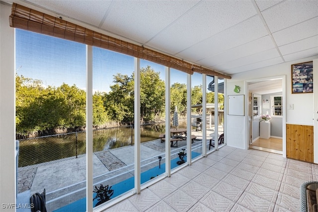 unfurnished sunroom featuring a paneled ceiling