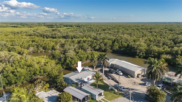 birds eye view of property featuring a view of trees