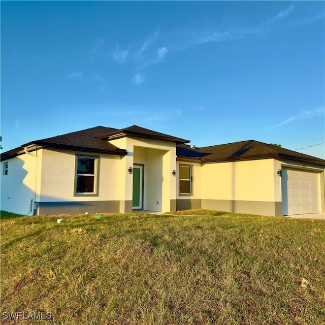 exterior space featuring a garage, a lawn, and stucco siding