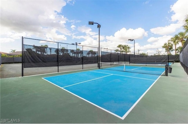 view of sport court with fence