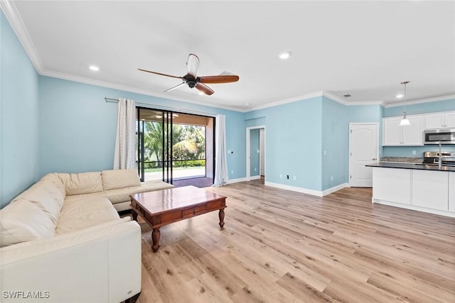 living area featuring baseboards, ceiling fan, recessed lighting, and light wood-style floors