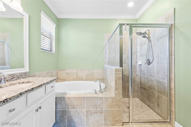 bathroom with a bath, a shower stall, crown molding, and vanity