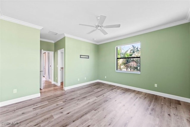 empty room featuring ceiling fan, ornamental molding, wood finished floors, and baseboards