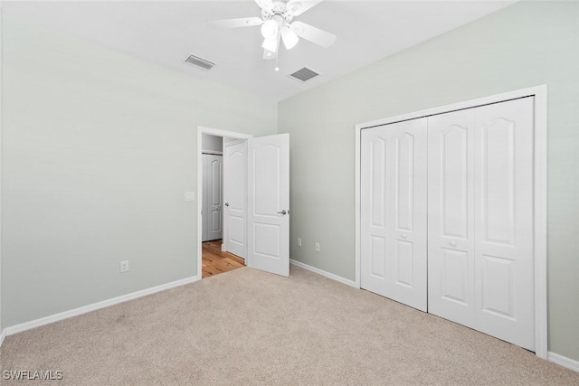 unfurnished bedroom with carpet floors, baseboards, visible vents, and a closet