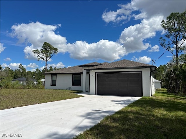 view of front of home featuring driveway, a front yard, an attached garage, and stucco siding