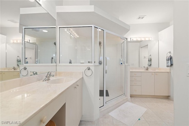 bathroom with a shower stall, visible vents, a sink, and tile patterned floors