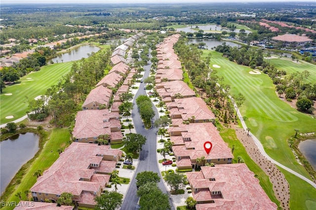 birds eye view of property with a water view and golf course view