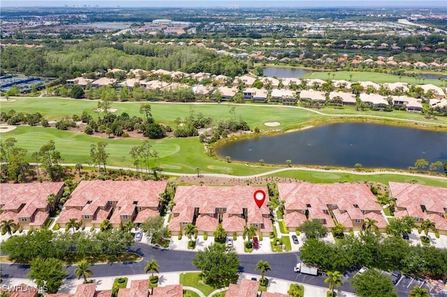 birds eye view of property with golf course view, a water view, and a residential view