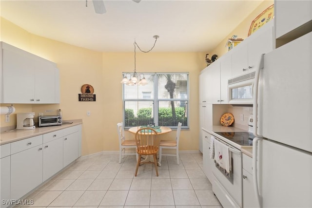 kitchen featuring light tile patterned floors, white appliances, white cabinetry, light countertops, and decorative light fixtures