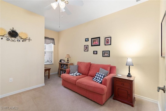 living room with carpet, ceiling fan, and baseboards