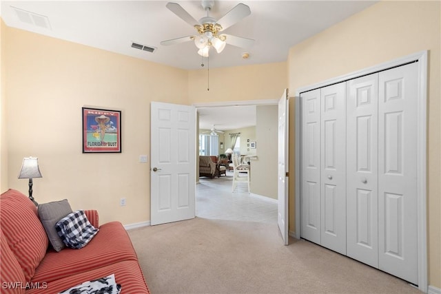 living area featuring light carpet, baseboards, visible vents, and a ceiling fan