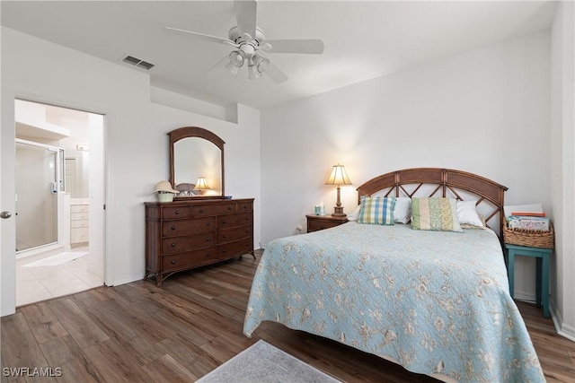 bedroom featuring ceiling fan, visible vents, connected bathroom, and wood finished floors