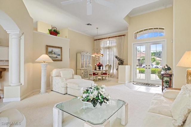 living room featuring carpet floors, visible vents, french doors, ornamental molding, and decorative columns