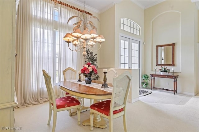 dining area featuring carpet, a notable chandelier, and crown molding