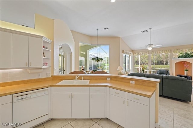 kitchen with visible vents, a peninsula, white dishwasher, open shelves, and a sink