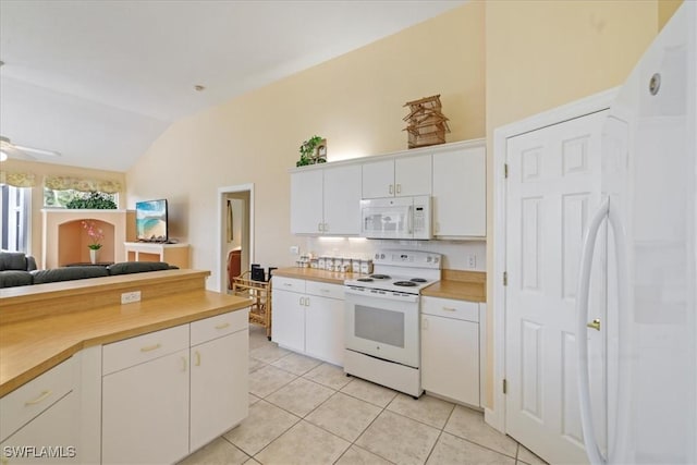 kitchen with white appliances, light tile patterned floors, open floor plan, vaulted ceiling, and light countertops