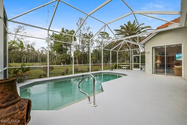 outdoor pool featuring a patio and glass enclosure