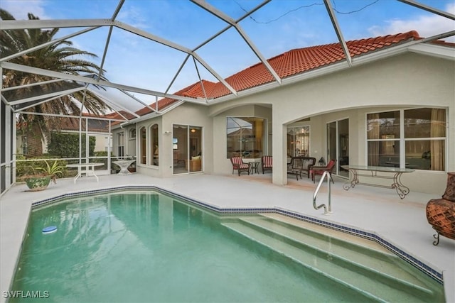 outdoor pool with a lanai and a patio