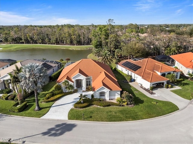 birds eye view of property featuring a forest view and a water view