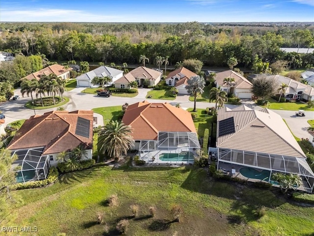 birds eye view of property featuring a residential view and a view of trees