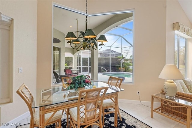 dining area featuring a sunroom, tile patterned flooring, baseboards, and a notable chandelier