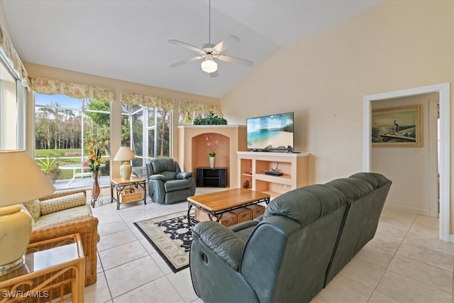 living room with lofted ceiling, ceiling fan, and light tile patterned flooring