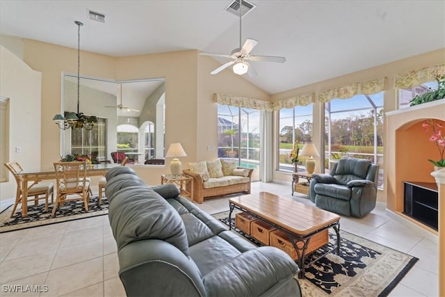 living room featuring light tile patterned floors, ceiling fan with notable chandelier, and visible vents