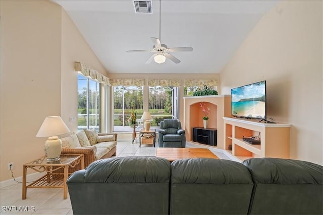 living room with a ceiling fan, visible vents, vaulted ceiling, and light tile patterned floors