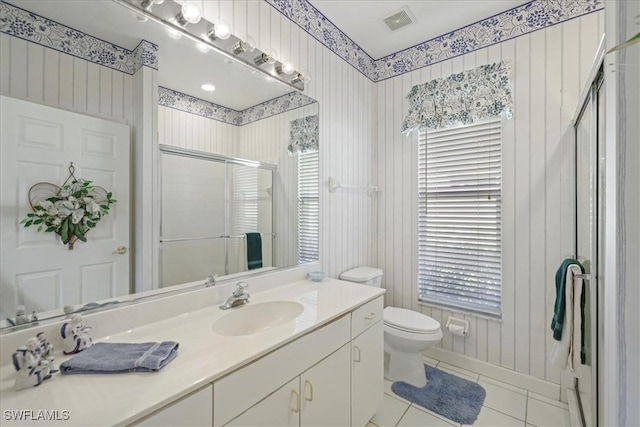 bathroom with a stall shower, visible vents, toilet, tile patterned flooring, and vanity