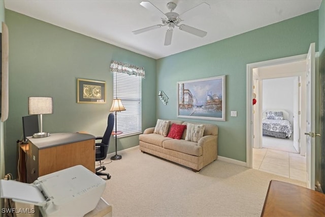 tiled office featuring ceiling fan, carpet floors, and baseboards