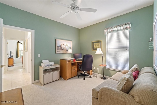 office featuring light carpet, baseboards, and a ceiling fan