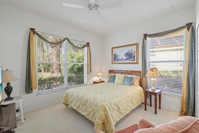 bedroom with a ceiling fan, baseboards, and carpet flooring